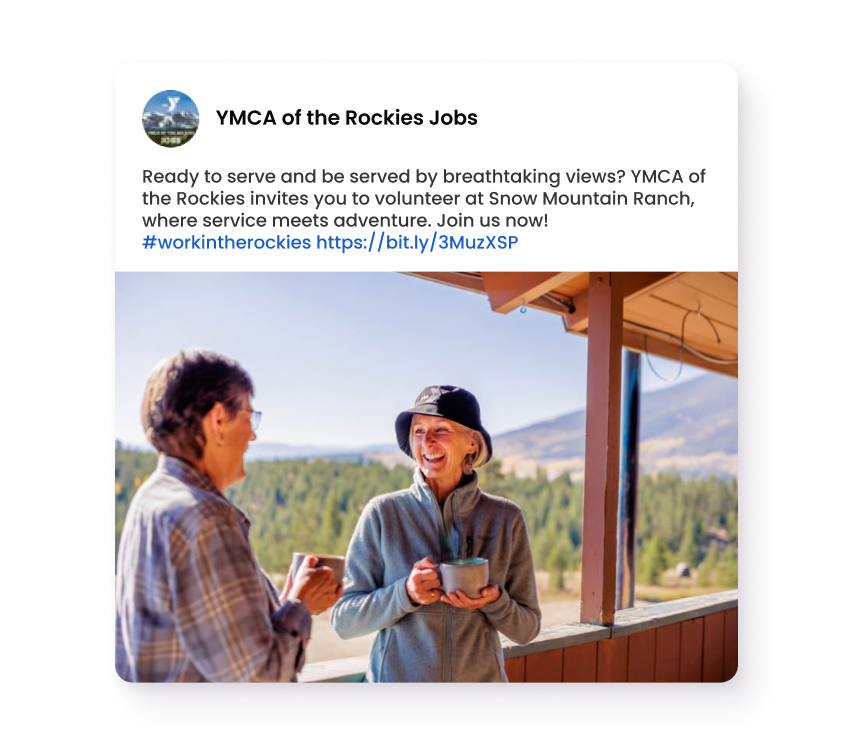 Two people smiling and holding mugs on a scenic mountain lodge porch
